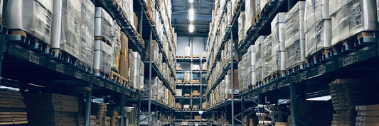 Racking full of palletised cartons in a distribution warehouse