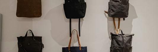 Black bags lined up on a retail display shelf