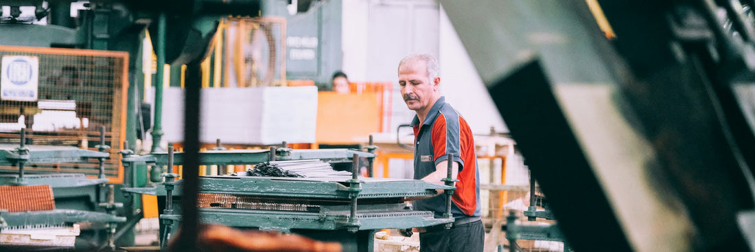 Machine operator working at an industrial production line