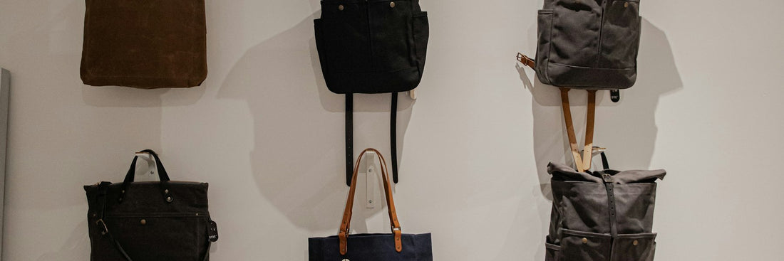 Black bags lined up on a retail display shelf