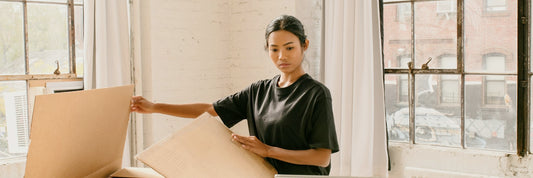 Small business owner packing customer orders from stock boxes