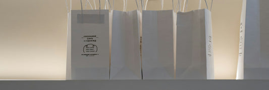 A row of bags lined up along a retail shelf