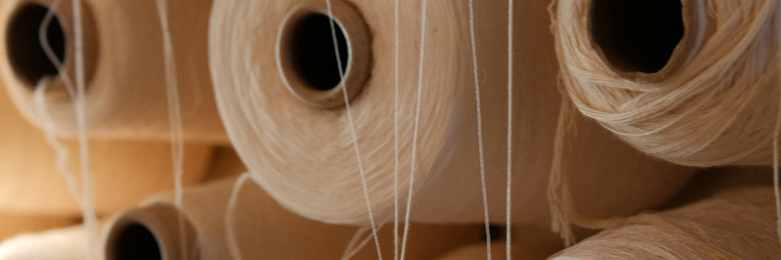 Neatly stacked spools of yarn in a textile mill