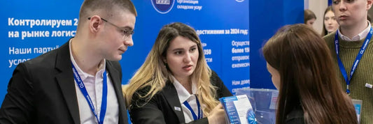 Buyers talking to exhibitors at a trade show booth