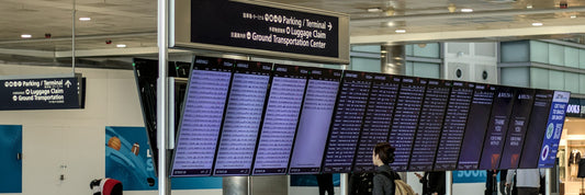 Traveller with a backpack checking an airport departure board